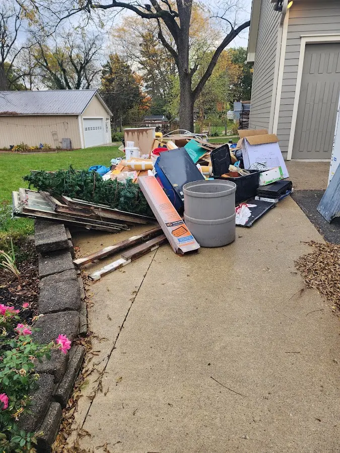 Dumpster being loaded with debris for Estate Cleanout Dumpster Rental in Frisco